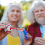 What is the 25 times rule for retirement? - So beautiful. Selective focus of a soap bubble being blown by joyful elderly people