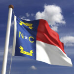 cost of living in North Carolina - NC flag waving in the wind